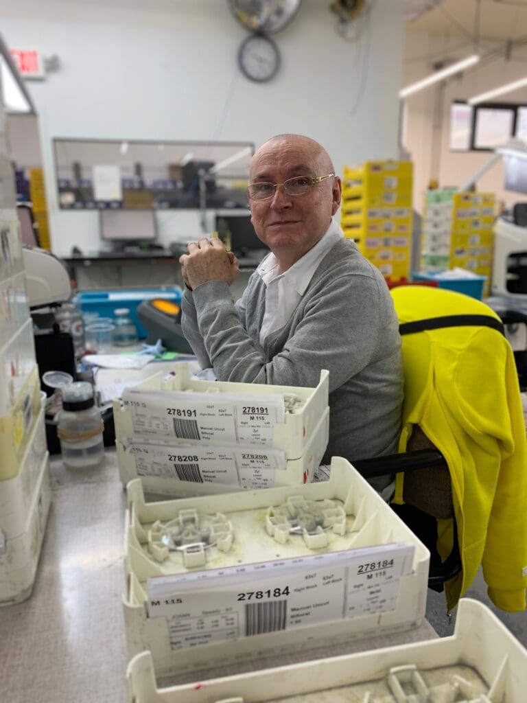 A man sitting at a table with boxes of food.