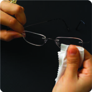 Removing temporary coating on lens with soft cloth