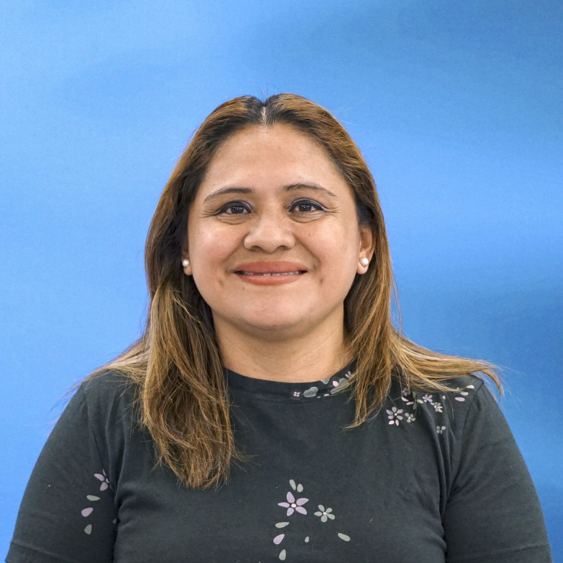 A woman with long hair and a black shirt