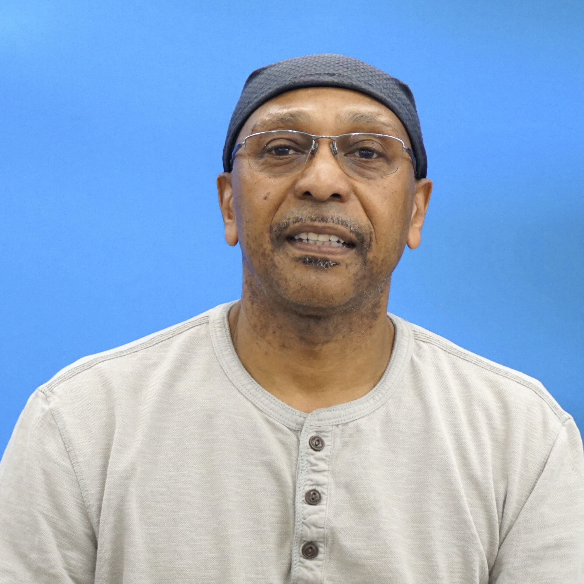 A man with glasses and a hat on