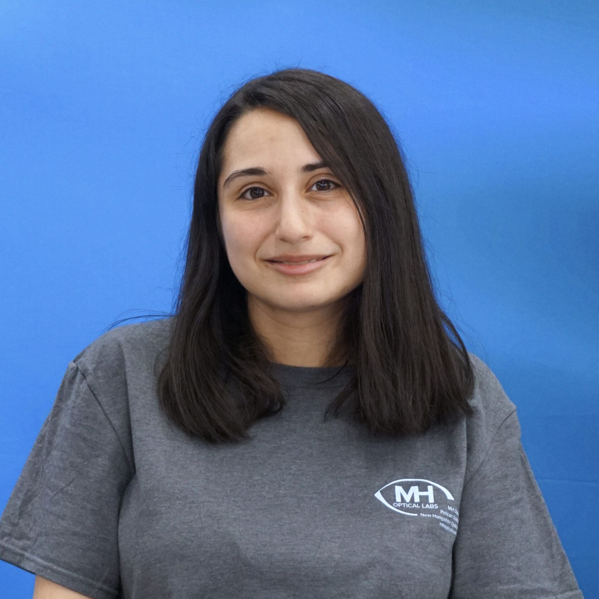 A woman with long hair wearing a gray shirt.