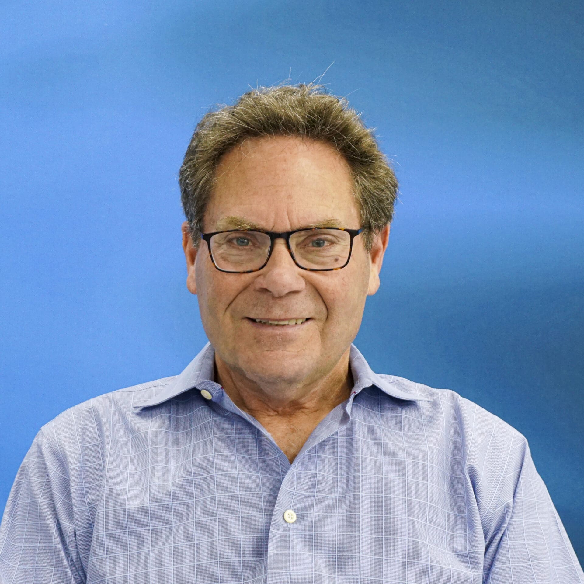 A man with glasses and a blue shirt