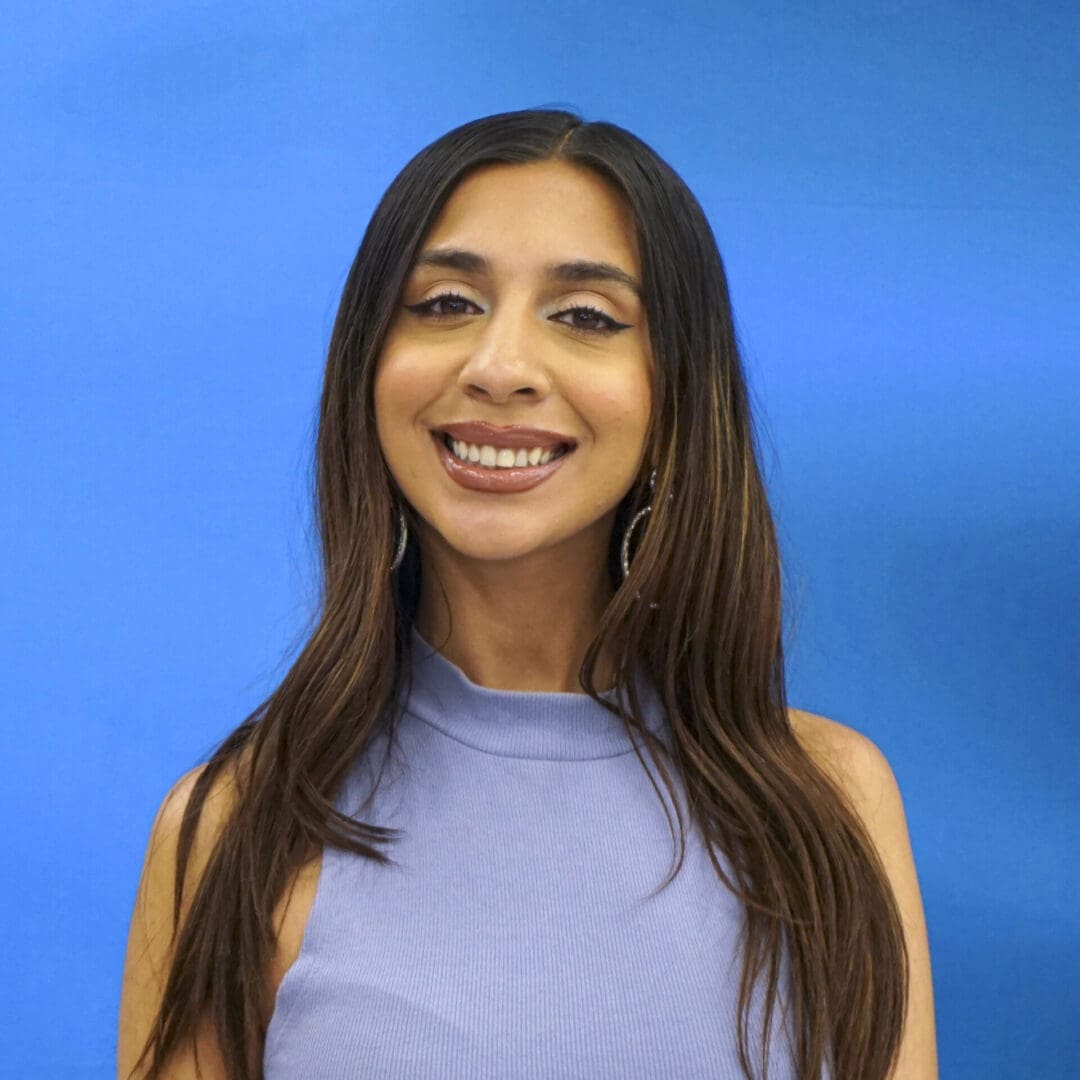 A woman with long hair and a blue shirt.