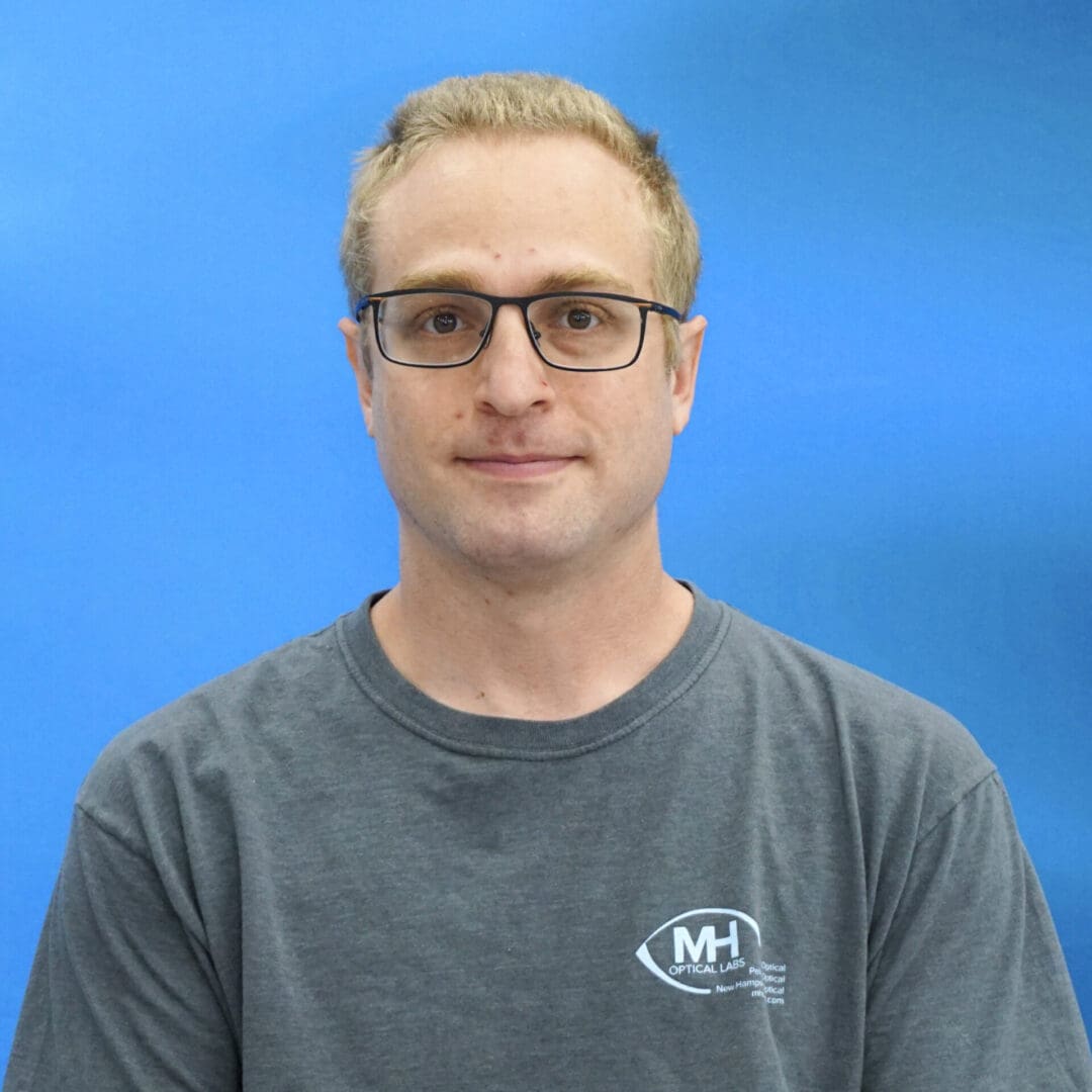 A man with glasses and a gray shirt