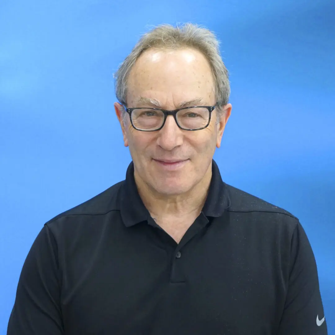 A man with glasses and a black shirt