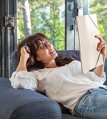 A woman is reading on the couch