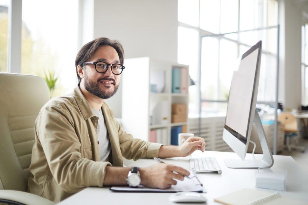 A man sitting at his desk with a computer.