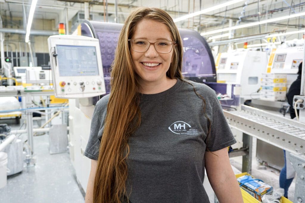 A woman standing in front of machines and machinery.